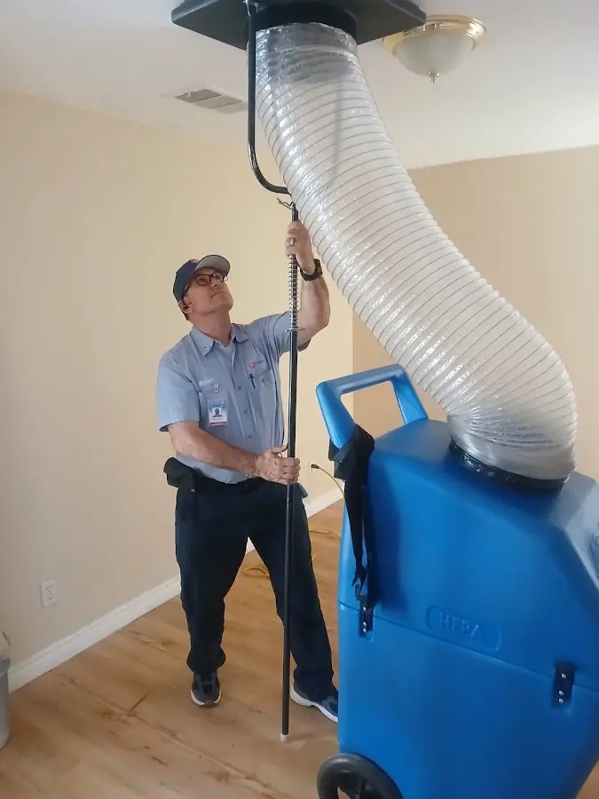 Furnace Tune-Up technician using HEPA equipment in Lamar